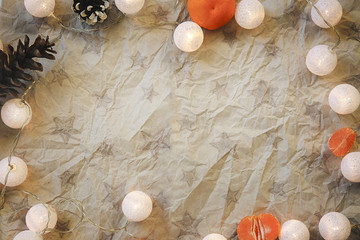 Vintage greeting   christmas background with copy space. Bright garland, fir cones, tangerines