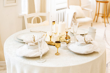 Festive Christmas table setting in white tones