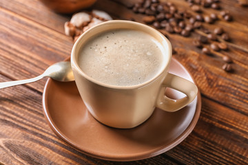 Cup of tasty aromatic coffee on wooden table
