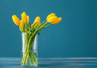 Vase with beautiful tulips on wooden table