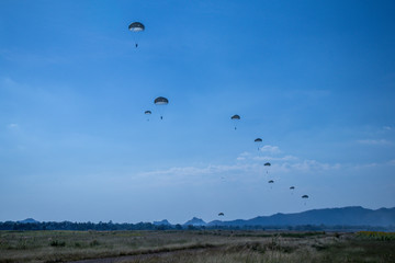  Jump of paratrooper with white parachute, Military parachute jumper in the sky.