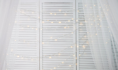white wood wall christmas background with shiny lights