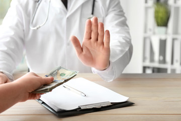 Doctor refusing to take bribe. Corruption concept