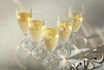 Glasses of champagne on grey table