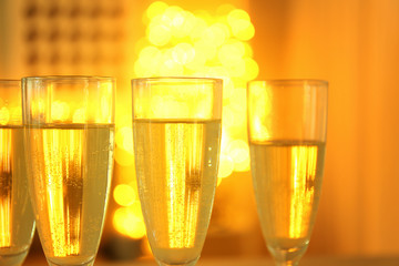Glasses of champagne on blurred background, closeup