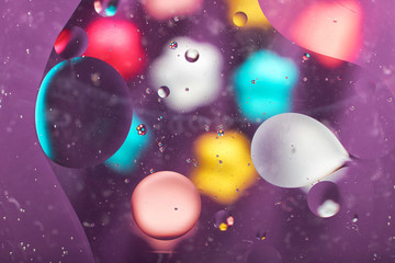 abstract background texture of colored oil droplets in the water