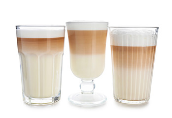 Glasses of tasty aromatic latte on white background