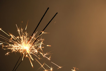 Obraz premium Festive Christmas sparklers on color background