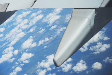 Airplane wing during the flight above the earth.