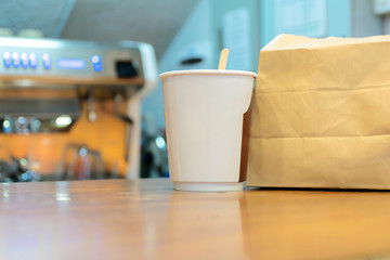 Coffee paper and brown paper bags are the packaging placed on the counter shop.