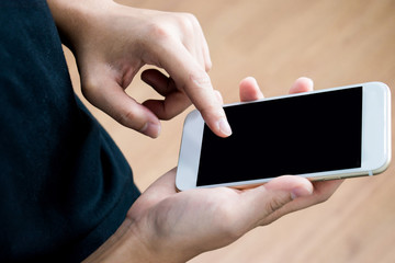 Close-up photo of a man using a phone in the room. Concept Technology Contact. Top view.