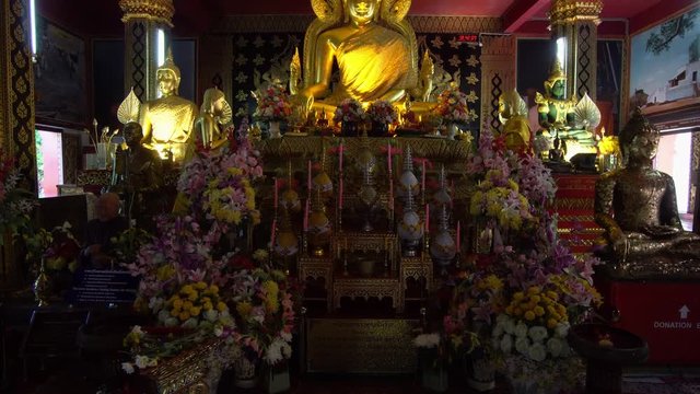 Interior of Traditional Asian Temple with Golden Statue of Earth Touching Buddha in Thailand
