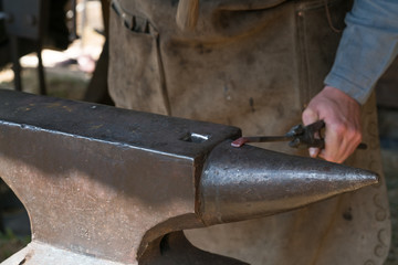 Blacksmith at work with hammer and anvil