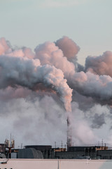 Fototapeta na wymiar Vertical image of industrial chimneys with heavy smoke causing air pollution