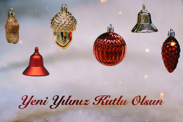 Shiny gold and red christmas balls and bells for new year. Yeni yılınız kutlu olsun means happy new year