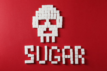 Naklejka premium Word SUGAR with skull on color background