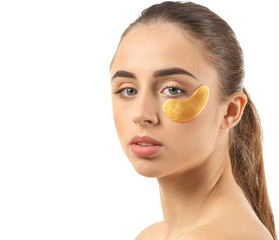 Beautiful young woman with under-eye patch on white background