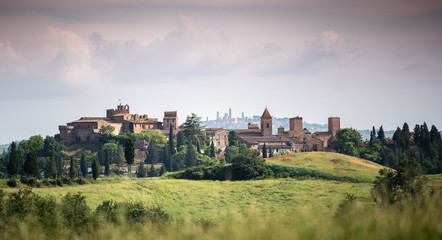 Fototapeta na wymiar Scenic panorama of medieval village of Certaldo old town, Italy, with San Gimignano towers in the background, typical Italian and Tuscany countryside landscape