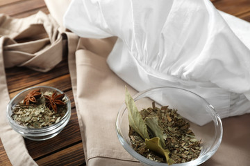 Bowls with spices and chef's hat on table