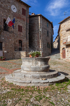 A Travertine Well In The Centre Of Ancient Square Named After The Painter Vecchietta In Medieval Town Of Castiglione D'Orcia, Italy