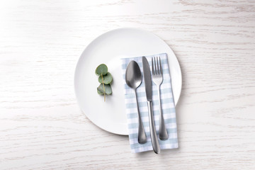 Table setting on white wooden background