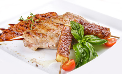 Pork steak with vegetable salsa on white background