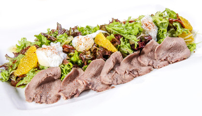 Beef roast beef with lettuce and oranges on a white background