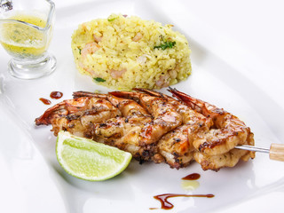 King prawns grilled on a skewer with rice