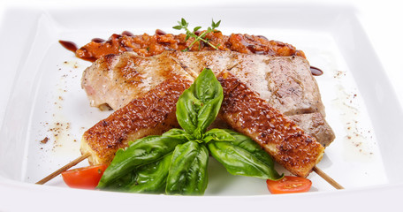 Pork steak with vegetable salsa on white background