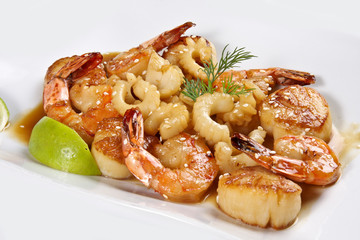 Seafood WOK. Fried shrimp, calamari and scallops on a white background