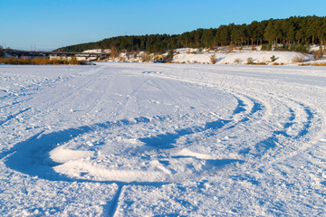 Fototapeta na wymiar Track on the white snow in winter 
