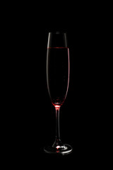 Glass of rose champagne on dark background