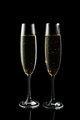 Glasses of champagne on dark background