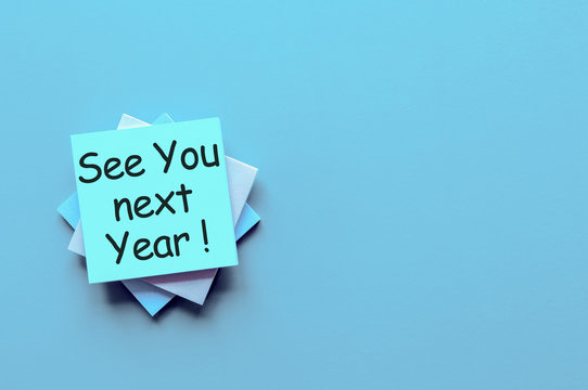See you next year written on a note pile at the office, mockup. Empty text for text
