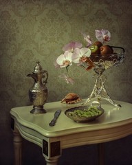 Still life with kiwi and orchid branch