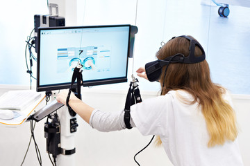 Woman on stand with virtual reality device for rehabilitation - obrazy, fototapety, plakaty
