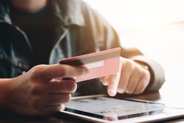Online payment,Man's hands credit card and using digital tablet computer for online shopping. Cyber Monday Concept