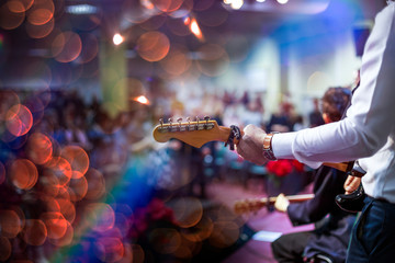 Fototapeta na wymiar Artist playing an acoustic guitar on stage.