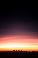 Fototapeta premium The contour of the city against the sunset sky.
