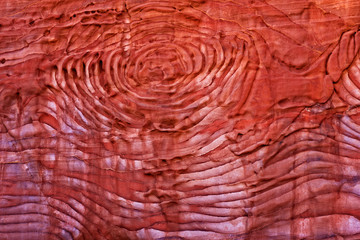 Fragment of rock in the 1.2km long path (As-Siq) in the city of Petra Jordan. Red rock background, sunset light in Petra, Jordan, Middle East. Civilization