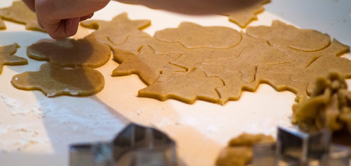 Fototapeta premium Making gingerbread cookies. Christmas baking background dough and cookie cutters