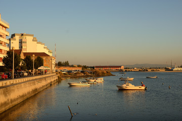 sunset overlooking the bay and boats, barreiro, lisbon