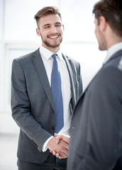 Fototapeta premium smiling business partners shaking hands.