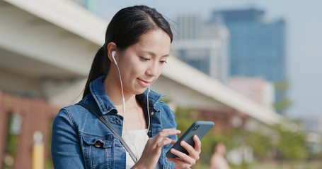Woman listen to music on earphone