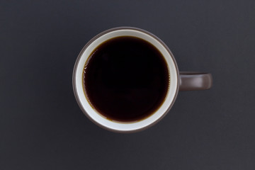 Cup of coffee on the gray background. Top view, flat lay, copy space, card layout