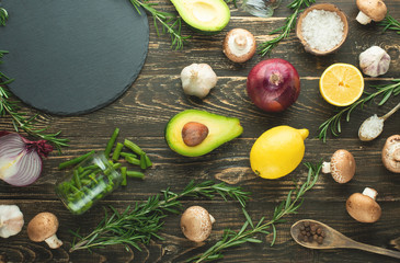 Lemon, rosemary avocado broccoli onion seasoning mushrooms. View from above, cooking background. Kitchen, home cooking, recipe book. Healthy and tasty food