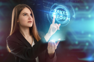 The concept of business, technology, the Internet and the network. A young entrepreneur working on a virtual screen of the future and sees the inscription: taxes reform