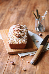 Walnut Financier - traditional French cake - with Crumble Topping,  on wooden table. 

