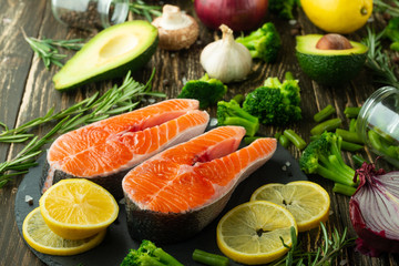 Fresh fish steak trout, salmon, salmon, red fish meat. With ingredients and vegetables on a wooden background, Flat-lay, Clean and healthy food.vegetarian