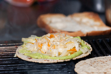 Corn tortilla roasted in charcoal accompanied by sausages and meat with sauces Guatemalan dish, fast street food, called MIXTA.